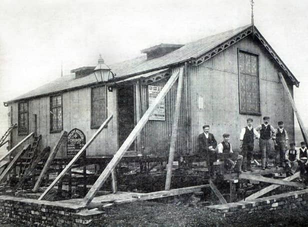 "Th'owd Tin Chapel" which preceded the present brick building of Gidlow Methodist Church on the corner of Barnsley Street and Buckley Street.
The picture shows the chapel being set in position around 1904 on what was then sandy wastes. The men in the picture are church officials and contractors. The iron church was demolished in 1949. 