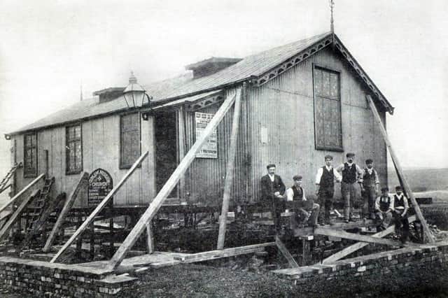 "Th'owd Tin Chapel" which preceded the present brick building of Gidlow Methodist Church on the corner of Barnsley Street and Buckley Street.
The picture shows the chapel being set in position around 1904 on what was then sandy wastes. The men in the picture are church officials and contractors. The iron church was demolished in 1949. 