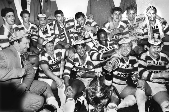 The champagne flows in the Wigan dressing room as the team celebrate with the trophy after beating Halifax in the Challenge Cup Final at Wembley on Saturday 29th of April 1988. Wigan won the match 32-12.