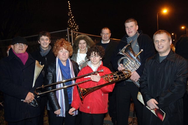 Members of Wigan Youth Brass Band at the Christmas tree lights switch on at Marus Bridge Health Centre and Hawkley Brook Surgery, the first in the area at buildings which are set to become a community centre, with local councillors who have part funded the tree with money from the Brighter Borough Fund:  Rona Winkworth, organiser, William Wilkes, left, and Stanley Barnes.  Wigan Council also helped with the cost.