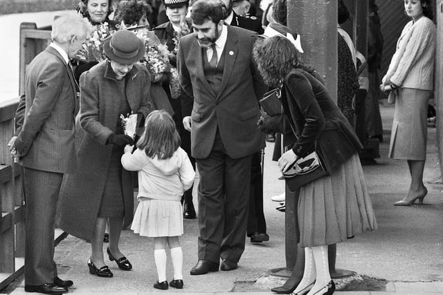 Four year old Louise Leatherbarrow enjoys her big moment as she presents a posy to the Queen watched by Wigan Council leader Bernard Coyle and Wigan Piermaster Peter Lewis. Louise, from Westhoughton, was the daughter of a Wigan Council architectural technician.