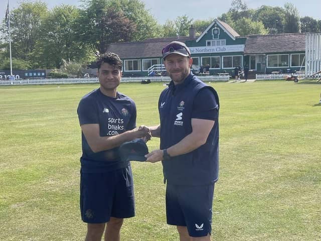 Adnan Miakhel receives his Lancashire cap from Steven Croft