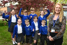 Headteacher Cathy Whalley and pupils at Winstanley Community Primary School celebrate their "outstanding" Ofsted report
