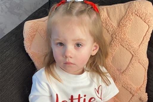 Lottie is impressed to be wearing something red for nursery.