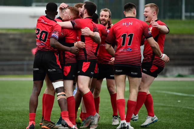 London Skolars celebrate after Omani Caro scores a try against Workington Town in 2019