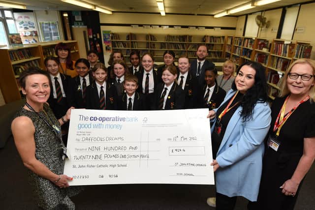 Headteacher Alison Rigby, left, with staff and pupils, presents the cheque to Emily Durkin-Kenyon and Maureen Holcroft, from Daffodils Dreams