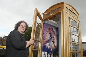 Tracy Kendall, customer services assistant at Atherton Library, with the phone box painted gold in honour of Keely Hodgkinson's Olympic success