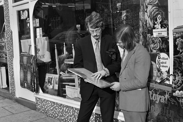 An advertising rep from the Post and Chronicle selling newspaper space to a shop owner in Wigan town centre in 1971.
