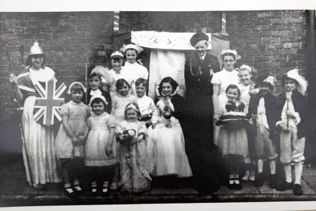 Jubilee memories - Wigan Observer reader Lois Gregory, pictured as the Queen (centre) with David Flanigan as the Duke of Edinburgh, pictuerd with children from Chapel Street, Queen Street, Princess Street, Vine Grove and Wood Street, Wigan - celebrating  the Queen's Coronation 70 years ago - this pictured was printed in the Wigan Observer.