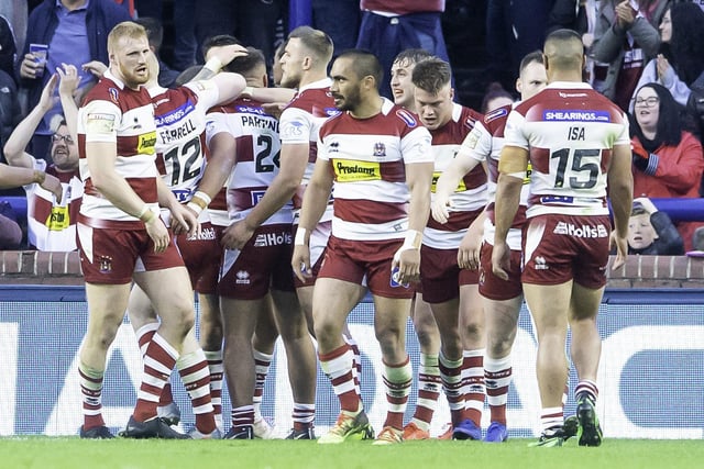 Wigan Warriors celebrate Partington's try against Leeds at Headingley.