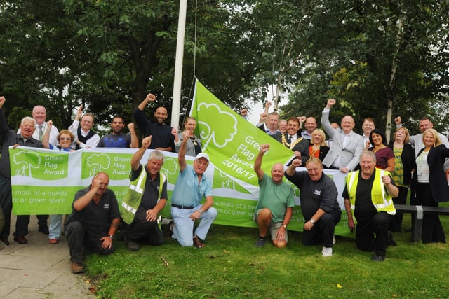 Flashback: The former Mayor of Wigan Coun Ron Conway raises the prestigious Green Flag awarded to Alexandra Park surrounded by Wigan Council staff and members of Friends of Alexandra Park in 2016