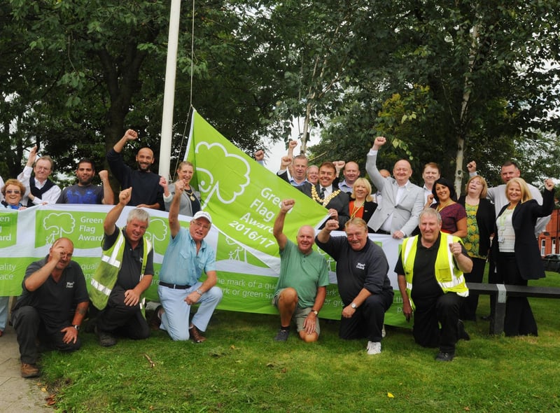 Flashback: The former Mayor of Wigan Coun Ron Conway raises the prestigious Green Flag awarded to Alexandra Park surrounded by Wigan Council staff and members of Friends of Alexandra Park in 2016