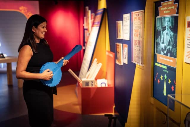 Lisa Nandy strums along with a film of WIgan-born George Formby during her visit to Blackpool