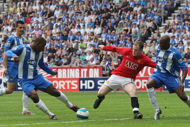 Wayne Rooney of Manchester United clashes with Titus Bramble of Wigan Athletic during the Barclays FA Premier League match between Wigan Athletic and Manchester United at JJB Stadium on May 11 2008, in Wigan, England.