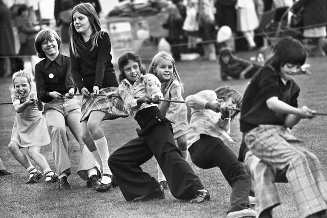 Plenty of pulling power from youngsters during a tug-o-war at St. Williams Gala, Higher Ince, in September 1975.