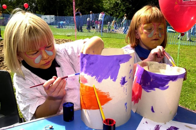 Kathryn and Stephanie fully absorbed in painting their hats at the Playday event at Lilford Park, Leigh, in 2000