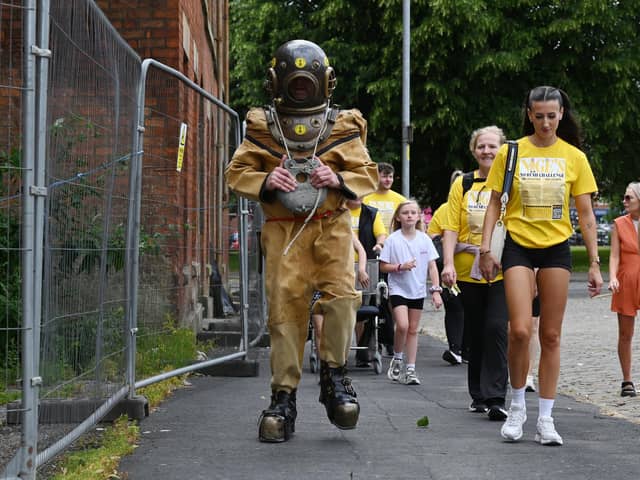 Nigel Brookwell spent six hours walking from Wigan to Standish in an 80kg vintage diving suit