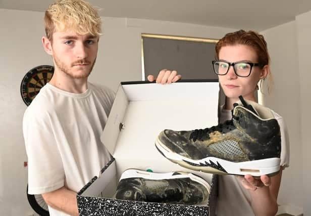 Jasmin Lyon and partner Aiden Gerrard who in 2023 had been living in a damp flat in Scholes for a year. Their property was mouldy and their health is suffering. They are pictured with a new pair of trainers which went mouldy in the shoebox because of the conditions in the accommodation
