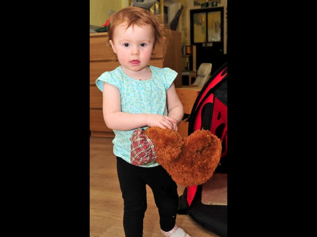 Taking teddy for a walk in the Toddlers Room