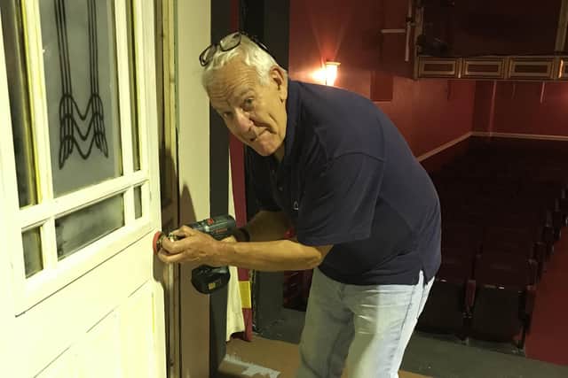 Director John Churnside works on the set at Wigan Little Theatre