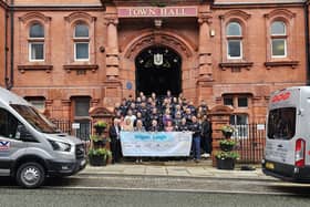 Team Wigan &amp; Leigh hikers alongside supporting businesses and charities.
