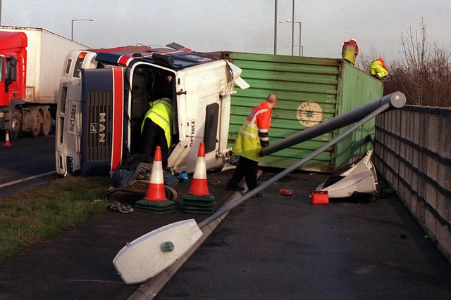 Recovery workers at the scene of an over-turned lorry on the East Lancs Road at the junction Atherleigh Way.