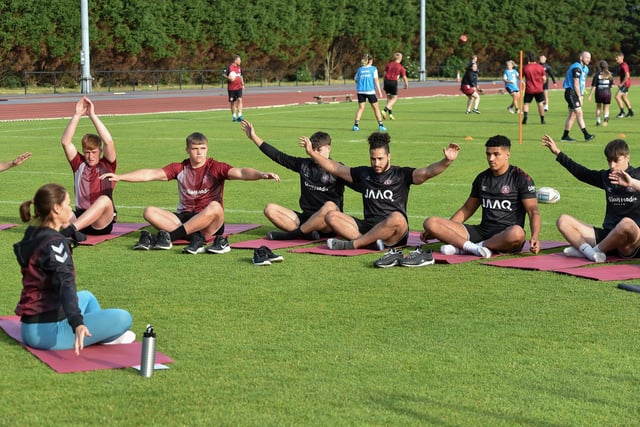 The players take part in a yoga session.