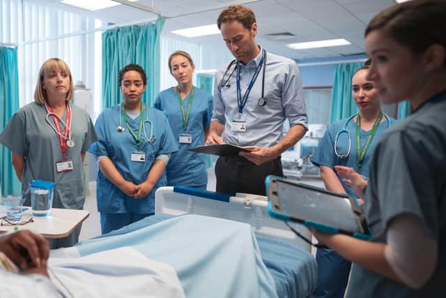 Helen (Lisa McGrillis, far left) has to do ward rounds with fellow doctor and estranged husband Guy (Oliver Chris, third from right) in new ITV drama Maternal