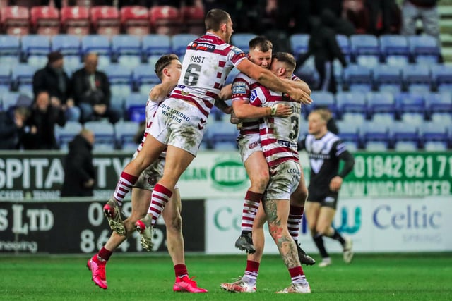 Wigan celebrate their narrow victory against Hull FC.