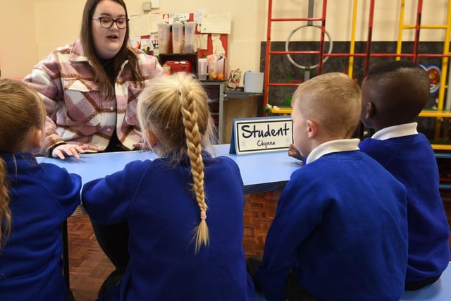 Pupils chat with a student in a careers day.