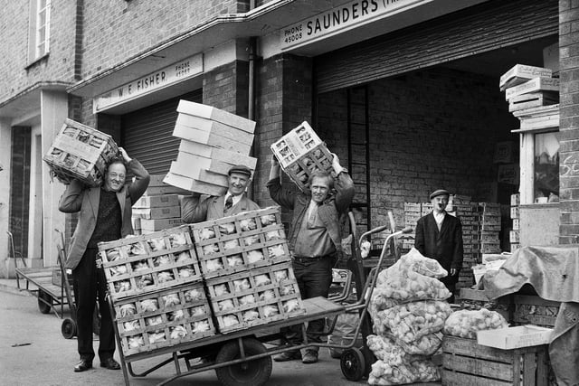 Unloading goods for Saunders fruit merchants at Wigan Old Market Hall in 1969.