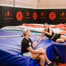 Keely Hodgkinson chats with coaches Trevor Painter and Jenny Meadows during a break in training at Wigan's Robin Park