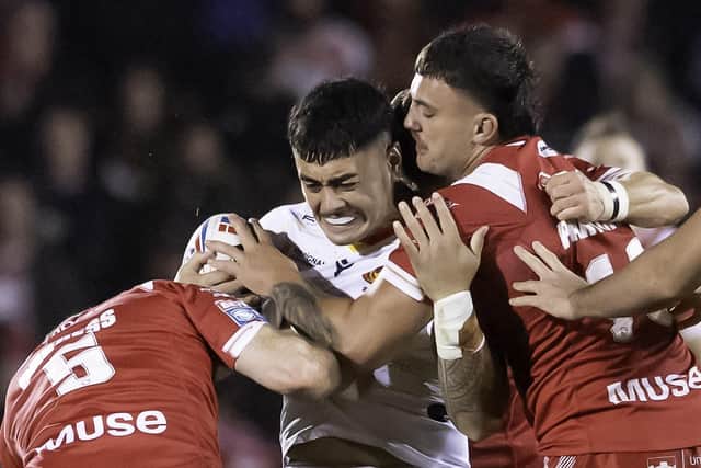 Harrison Hansen has predicted a bright Wigan Warriors future for Tiaki Chan, tackled by Salford's Oliver Partington and Joe Burgess
