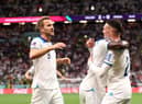 Bukayo Saka celebrates with Harry Kane and Phil Foden after scoring England's third goal against Senegal (Photo by Catherine Ivill/Getty Images)
