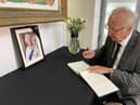 Council leader Coun David Molyneux signs the book of condolence