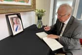 Council leader Coun David Molyneux signs the book of condolence