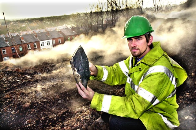 Site Manager, Mike Winch, with a lump of coal from the smouldering Broomfield Tip in Bradley Lane, Standish, in December 2003. 
Engineers started the massive project to extinguish the underground tip fire , which had been burning for 15 months, in October of that year.
Underground temperature probes revealed that the fire, which was being fuelled by the high deposits of coal at the tip, was burning up to a depth of 15 metres.