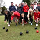 Members of Shevington Village Bowling Club at Forest Fold bowling green, teach the techniques of game to pupils from Millbrook Primary School, Shevington.