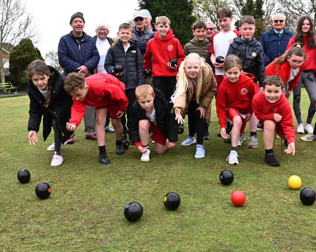 Members of Shevington Village Bowling Club at Forest Fold bowling green, teach the techniques of game to pupils from Millbrook Primary School, Shevington.