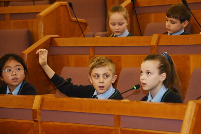 Pupils ask questions in the Council Chamber at Wigan Town Hall.