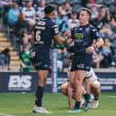 Bevan French (left) and Jai Field (right) celebrate a Wigan Warriors try in 2025