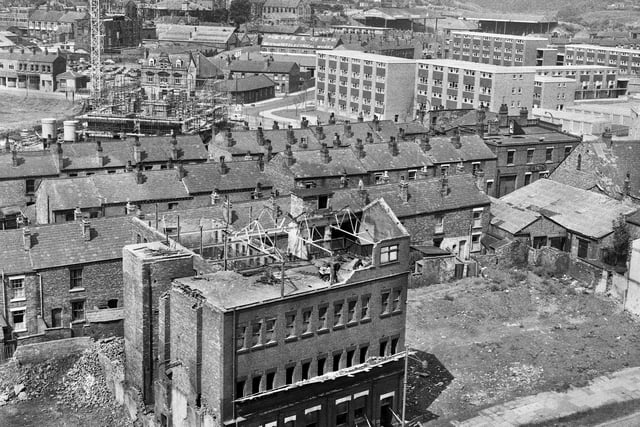 1966 - Anderton's sewing factory in Millgate is under demolition in the foreground with rows of houses in Bold Street and Low Street behind and the new maisonettes further back as the new Scholes rises in July 1966.