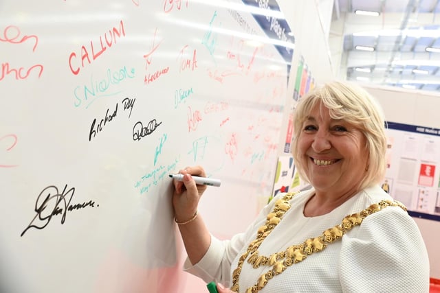 The Mayor of Wigan Coun Marie Morgan signs a visitors board to celebrate the official opening of Algeco.
