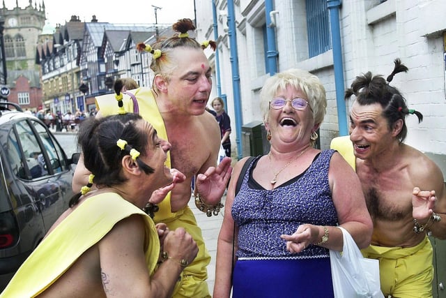 Jean Foster gets pestered in Wigan town centre, by The Obsessionels during the Maydayze Festival on May 2001.