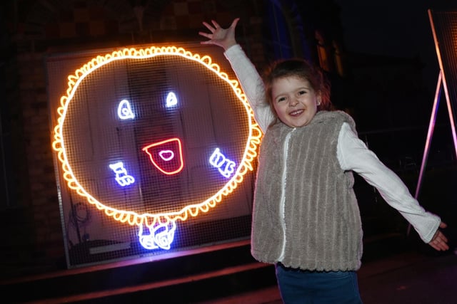 Darcie Bond, six, her winning drawing of Wigan Athletic mascot Crusty the Pie transformed into life-size neon artwork on display.