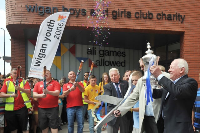 Life President Dave Whelan, right, with the FA Cup as founder chairman Martin Ainscough cut the ribbon to mark the official opening of Wigan Youth Zone.