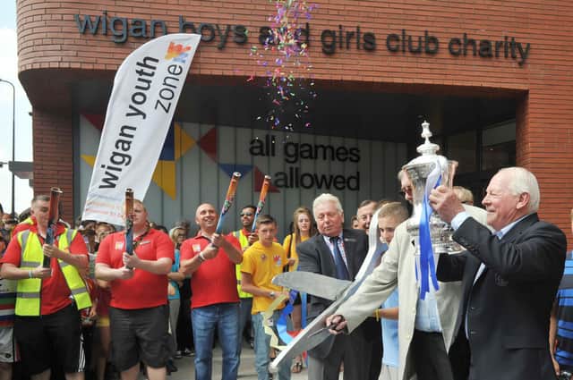 Life President Dave Whelan, right, with the FA Cup as founder chairman Martin Ainscough cut the ribbon to mark the official opening of Wigan Youth Zone.