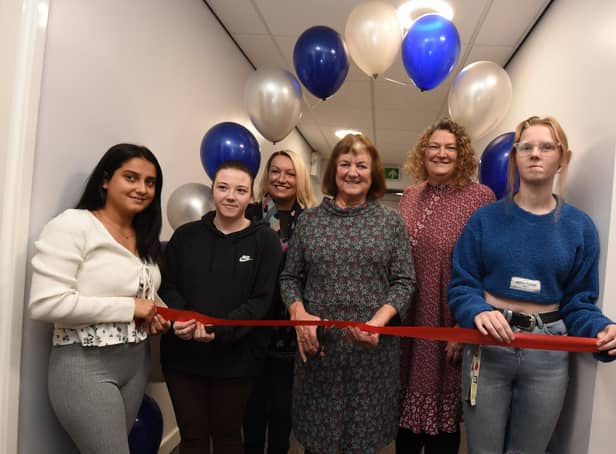 Coun Jenny Bullen, centre, cuts the ribbon to officially open the centre, pictured with care leavers and director of childrens services Colette Dutton, third from left, and Service Lead Children in Care & Care Leavers Jacqui Hardman, second from right.