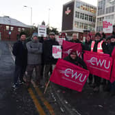 Members of the Communications Workers Union (CWU) and supporters brave freezing temperatures on the picket line outside Royal Mail's office on Hallgate, Wigan