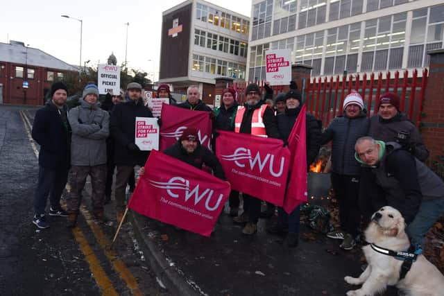 Members of the Communications Workers Union (CWU) and supporters brave freezing temperatures on the picket line outside Royal Mail's office on Hallgate, Wigan